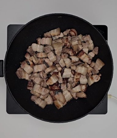Sautéing pork belly until lightly browned
