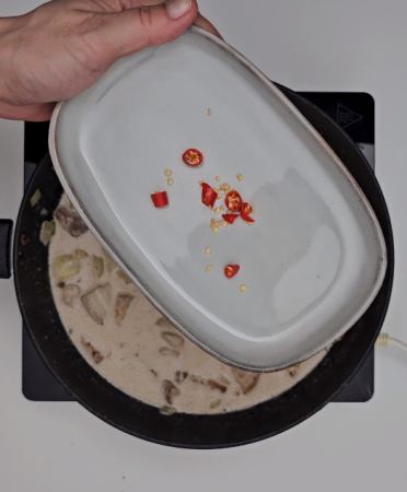 Adding the Thai chili peppers and season with salt and black pepper