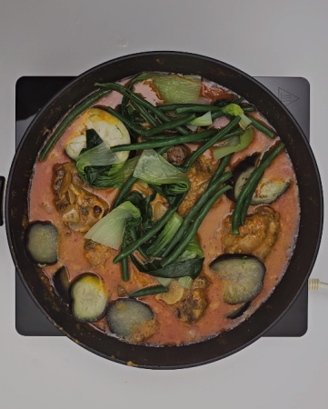 Filipino Kare Kare preparation step 5 - Adding the cooked vegetables to the meat and sauce