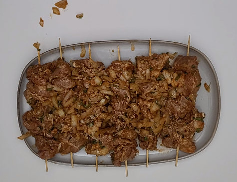 Moroccan Brochettes Preparation Step 2 - Threading the marinated meat onto skewers.